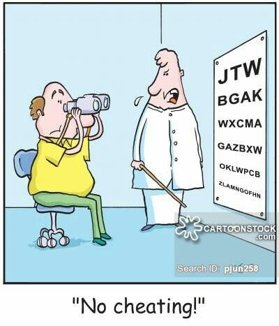Man looking through binoculars at an eye diagnostic chart.